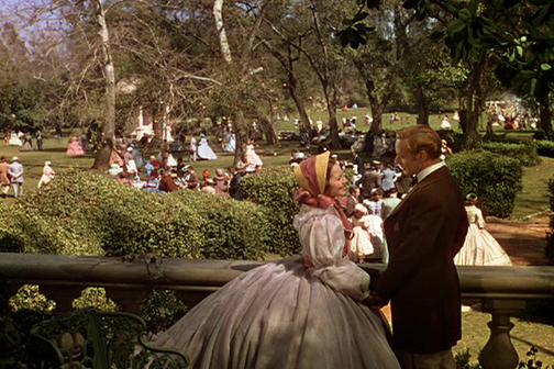 Victor Fleming. Gone With the Wind (1939). Screenplay by Sidney Howard based on Margaret Mitchell’s novel (1936). Selznick International Picture. Metro-Goldwyn-Mayer. Ashley Wilkes (Leslie Howard) and Melanie Hamilton (Olivia de Havilland) on the veranda overlooking the lawn and gardens at Twelve Oaks Plantation. 